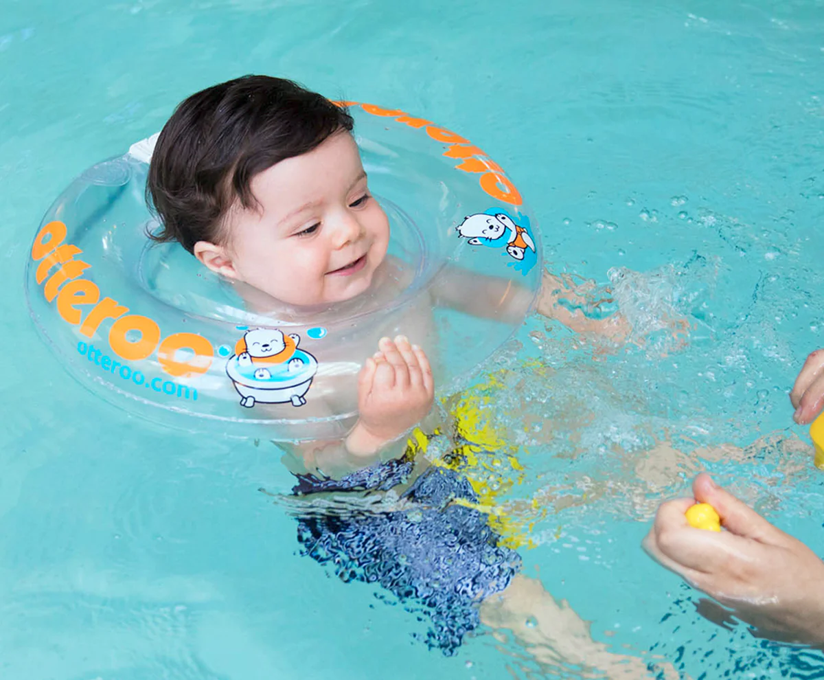 Babe are having fun playing in the pool with floats, vintage, Otteroo, beaming.